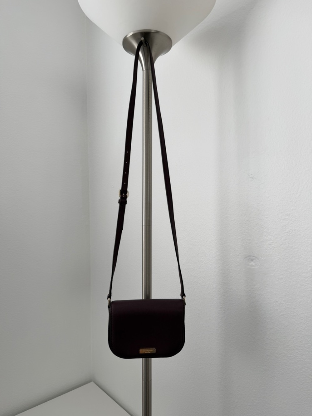 kate spade dark plum crossbody bag with gold-tone logo